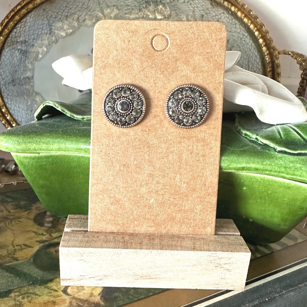 Pair of round, silver-toned, stud earrings with a central gray-colored stones